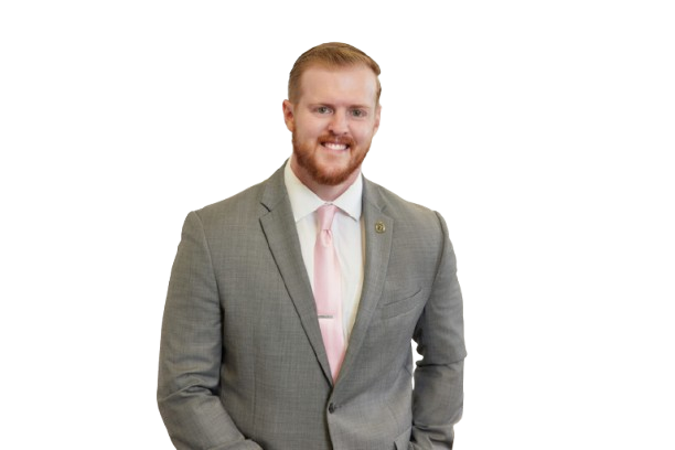 zac-1-scaled-removebg-preview A man in a suit and tie standing with his hands in his pockets.